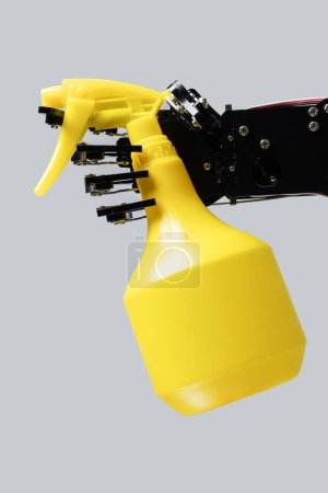 Photo for Real robot's hand with spray cleaner isolated on grey background. Concept of  robotic process automation. - Royalty Free Image