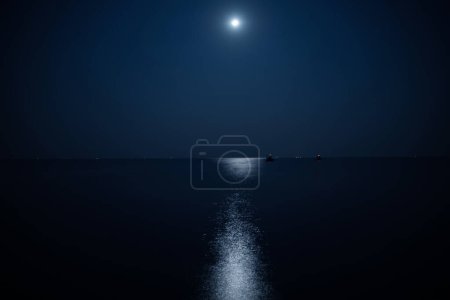 Photo for Beautiful calm sea illuminated by the moonlight at night - Royalty Free Image