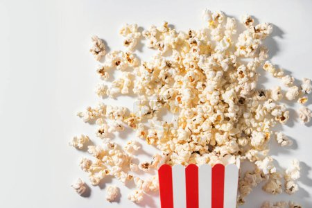 Photo for Classic striped bucket with delicious popcorn on white background. - Royalty Free Image