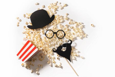 Photo for Popcorn bucket and photo booth prop for movie party on white background. - Royalty Free Image