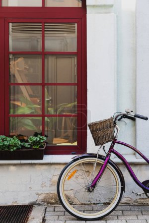 Photo for Purple vintage bicycle parked near old house in little European town - Royalty Free Image