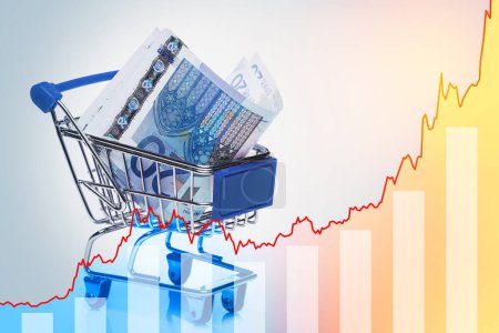 Photo for Euro banknotes in tiny shopping cart and rising sparkline chart. - Royalty Free Image