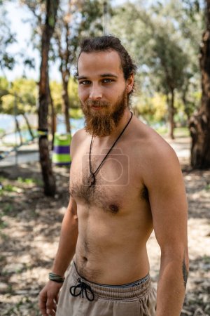 Photo for Outdoors portrait of young bearded man with naked torso - Royalty Free Image