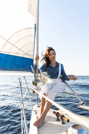 Photo for Portrait of attractive woman relaxing on sailboat during sailing in sea - Royalty Free Image