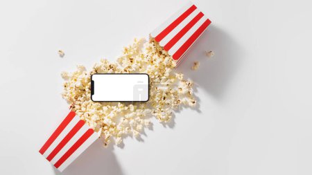 Téléchargez les photos : Seau popcorn classique et smartphone avec écran vierge pour votre design. - en image libre de droit
