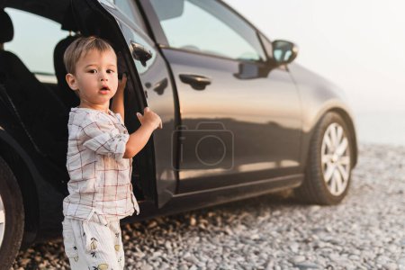 Photo for Toddler's beachside exploration during a road trip. - Royalty Free Image