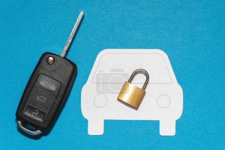 Photo for Black car key and to a cut-out car silhoutte with on blue background - Royalty Free Image