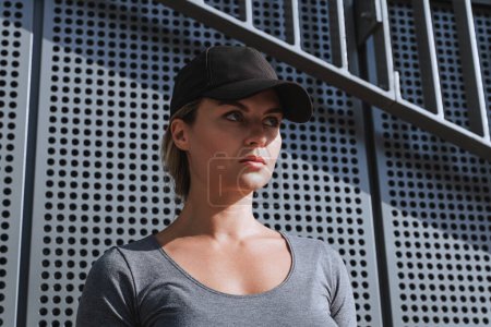 Photo for Portrait of confident woman athlete black baseball cap outdoor. - Royalty Free Image