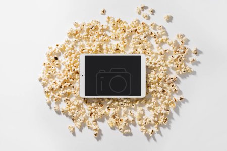 Téléchargez les photos : Dispersé délicieux pop-corn et tablette avec écran vierge pour votre conception - en image libre de droit