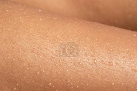 Photo for Closeup texture of wet tanned female skin - Royalty Free Image