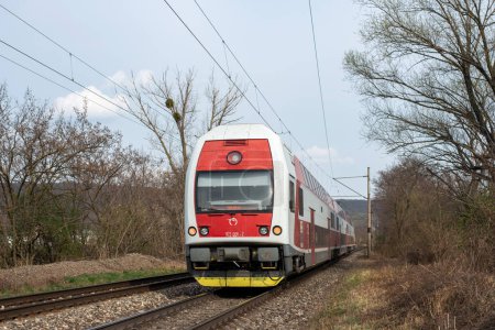 Photo for BRATISLAVA, SLOVAKIA - MARCH 29, 2022. Train Skoda Vagonka 1Ev #971 006-2 riding with passengers in the streets of Bratislava. - Royalty Free Image