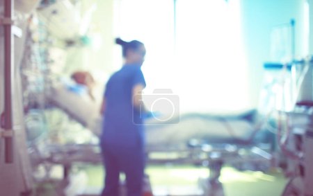 Foto de Medical blurred background: Nurse at work in a hospital ward. - Imagen libre de derechos