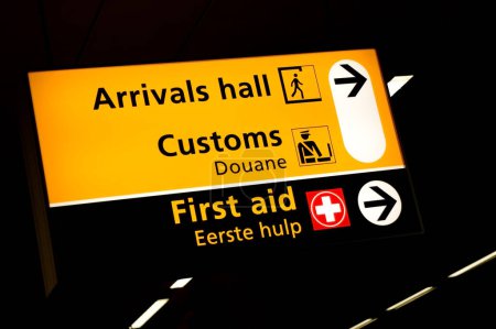 Photo for Arrivals, customs and first aid signs at the gates of Schiphol International airport in Amsterdam, the Netherlands - Royalty Free Image