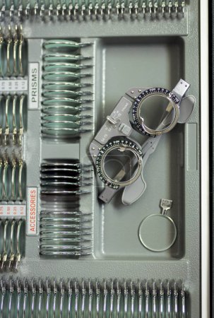 Optometrist trial frame with a replaceable lenses. Diagnostic ophthalmic eye equipment set.