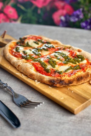 Photo for Fresh baked focaccia or pizza with mozzarella and pesto. selective focus. romana's pizza. - Royalty Free Image