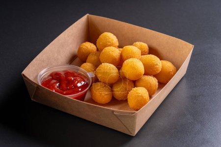 Photo for Potato croquettes - mashed potatoes balls breaded and deep fried, served with sauce. Deep potato or appetizer, fast food. Dish of crisp golden potato chips. - Royalty Free Image