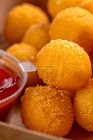 Photo for Potato croquettes - mashed potatoes balls breaded and deep fried, served with sauce. Deep potato or appetizer, fast food. Dish of crisp golden potato chips. - Royalty Free Image