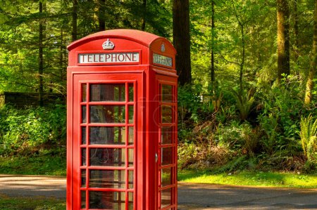 Photo for Warminster, England - May 2022: Vintage red Post Office telephone box in a wooded area. No people. - Royalty Free Image