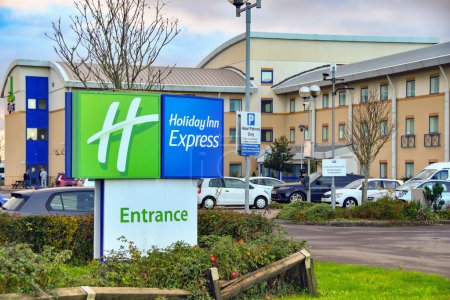 Photo for Rhoose, Wales - November 2022: Sign at the entrance to the Holiday Inn Express airport hotel at Cardiff Wales Airport - Royalty Free Image