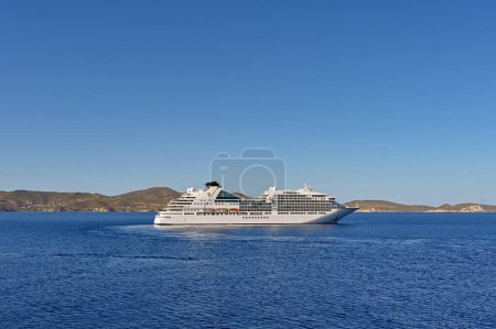 Photo for Patmos, Greece - May 2022: Luxury cruise ship Seabourn Encore turning in the bay off the coast of the Greek island of Patmos - Royalty Free Image