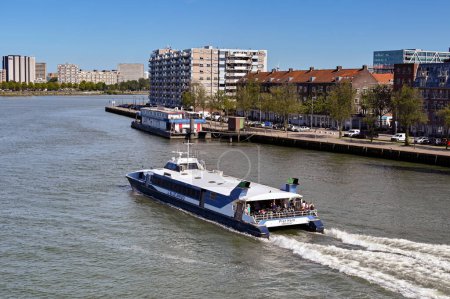 Photo for Rotterdam, Netherlands - August 2022: Water taxi on the Nieuwe Maas river in Rotterdam. The ferry service is operated by the Blue Amigo company. - Royalty Free Image