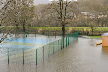 Photo for Taffs Well, Cardiff, Wales - January 2023: Village tennis court underwater after flooding from the River Taff - Royalty Free Image