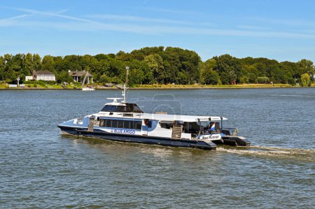 Photo for Dordrecht, Netherlands - August 2022: Small fast ferry operated by Blue Amigo sailing on the River Maas - Royalty Free Image