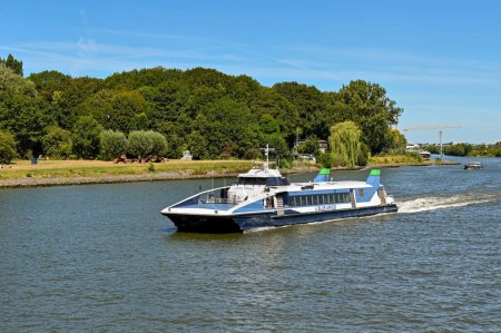 Photo for Dordrecht, Netherlands - August 2022: Small fast ferry operated by Blue Amigo sailing on the River Maas - Royalty Free Image