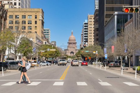 Photo for Austin, Texas, USA - February 2023: People crosssing one of the main streets in the city centre. In the background is the State Capitol building.. - Royalty Free Image