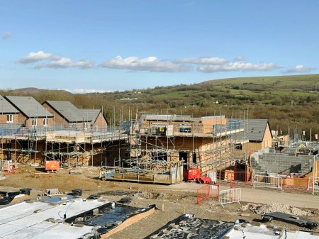 Photo for Pontypridd, Wales - April 2023: House foundations and unfinished detached houses on a new housng development in Church Village near Pontypridd - Royalty Free Image