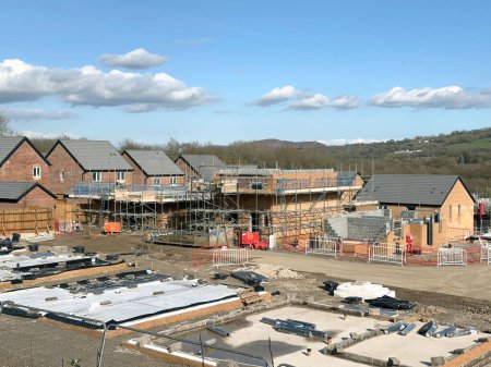 Photo for Pontypridd, Wales - April 2023: House foundations and unfinished detached houses on a new housng development in Church Village near Pontypridd - Royalty Free Image