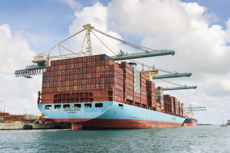 Photo for Miami, Florida, USA - 1 December 2023: Dockside cranes loading the Maersk container ship Gjertud Maersk in  Miami docks - Royalty Free Image