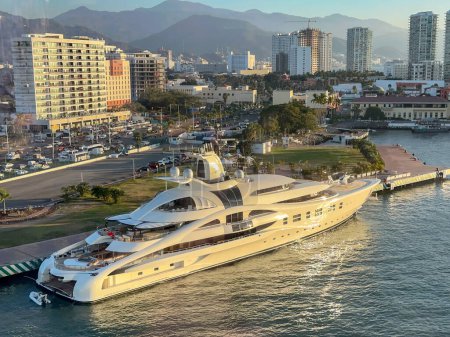 Photo for Puerto Vallarta, Mexico - 15 January 2024: Superyacht AV with a helicopter on deck moored in the port of Puerto Vallarta in evening subnlight. It is owned by Dennis Washington. - Royalty Free Image