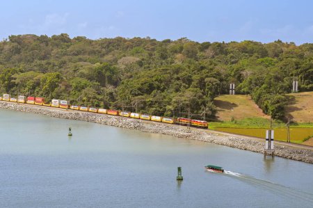 Photo for Panama - 22 January 2024: Diesel locomotives pulling a freight train of wagions carrying shipping containers on the Panama Canal Railway - Royalty Free Image
