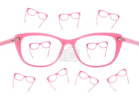 Glasses with pink frames seen in focus through the lens of a pair of glasses isolated on a plain white background. Focus concept.