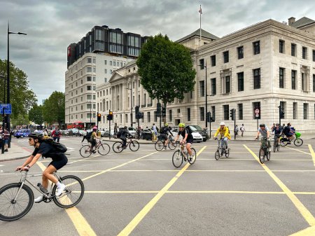 Photo for London, England, UK - 27 June 2023: Cyclists crossing a road junction near St Pancras railway station in central London - Royalty Free Image