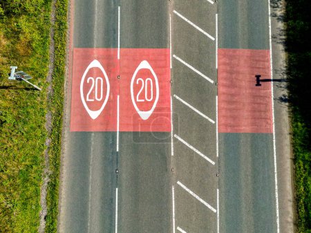 Drone view of road markings in Wales showing the start of a 20mph spped limit zone.