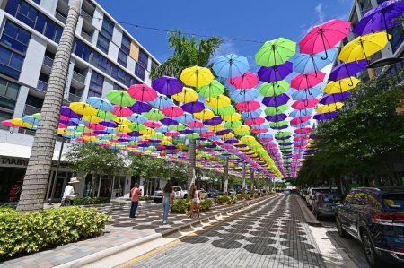 Photo for Doral, Florida - April 9, 2023 - Visitors enjoy canopy of colorful umbrellas suspended over Doral CityPlace boulevard on sunny sunday morning. - Royalty Free Image