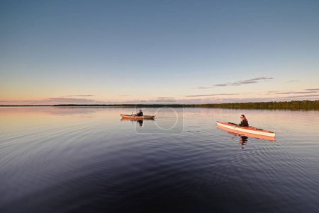 Photo for Two kayakers on calm water of Coot Bay in Everglades National Park, Florida at sunset. - Royalty Free Image