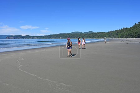 Photo for Hikers on Shi Shi Beach Trail in Olympic National Park near Neah Bay, Washington on sunny summer afternoon with Point of Arches in background. - Royalty Free Image