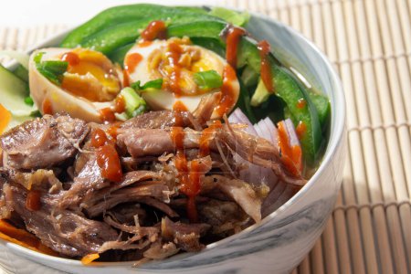 Photo for Delicious pulled braised duck meat ramen soup bowl loaded with eggs and veggies - Royalty Free Image