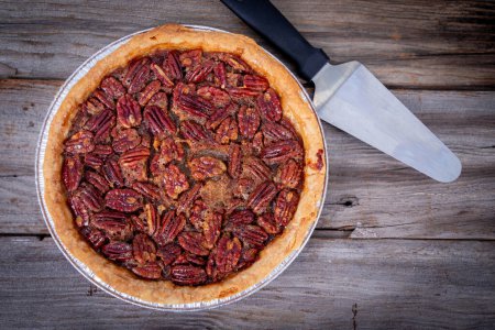 Photo for Delicious pecan pie high angle view on rustic wood table - Royalty Free Image