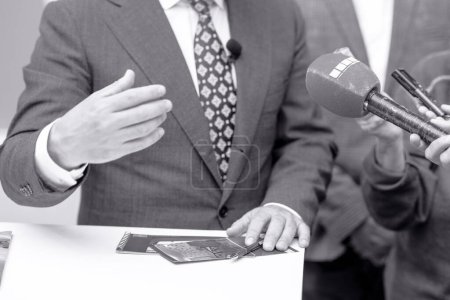 Photo for News or press conference or media interview with business person, digital voice recorder and microphone in focus - Royalty Free Image