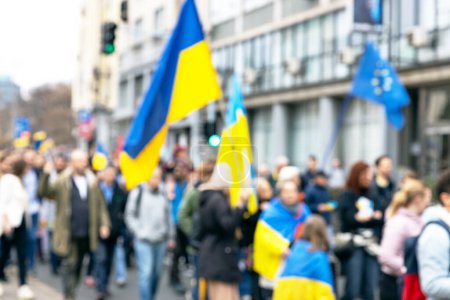 Anti-war protest, crowd of people with Ukrainian flags