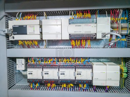 Foto de Mitsubishi PLC modules in a row in electrical cabinet of automation control system on industrial plant. KRYVYI RIH, UKRAINE - JANUARY, 2023 - Imagen libre de derechos