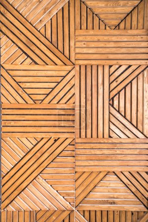 Photo for Geometric vertical wooden pattern on the wall of crisscrossing pine slats - Royalty Free Image