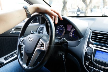 Photo for Man hand on Steering wheel in the cabin of a Korean Hyundai car. Selection and purchase of used car. Almaty, Kazakhstan, 05 april, 2022 - Royalty Free Image