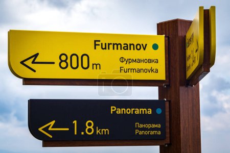 Photo for Pointer for tourists indicating directions to Mount Furmanov and Panorama Peak in the mountains of Almaty. Almaty, Kazakhstan - July 19, 2022 - Royalty Free Image