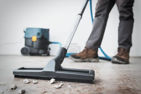 Photo for Professional construction cleaning service with powerful vacuum cleaner. - Royalty Free Image
