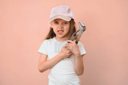 Photo for When dad wanted a son, but he is raising a daughter. Girl tomboy with a wrench. - Royalty Free Image